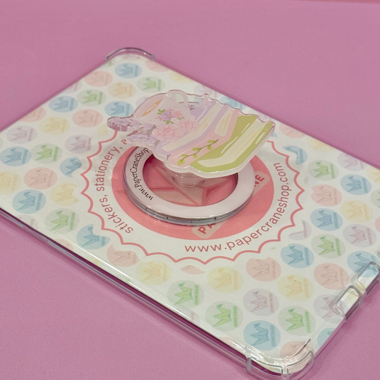 Phone ring holder with floral design on a pink background