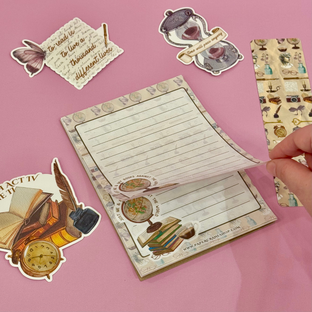 Decorative notepad with stickers on a pink background