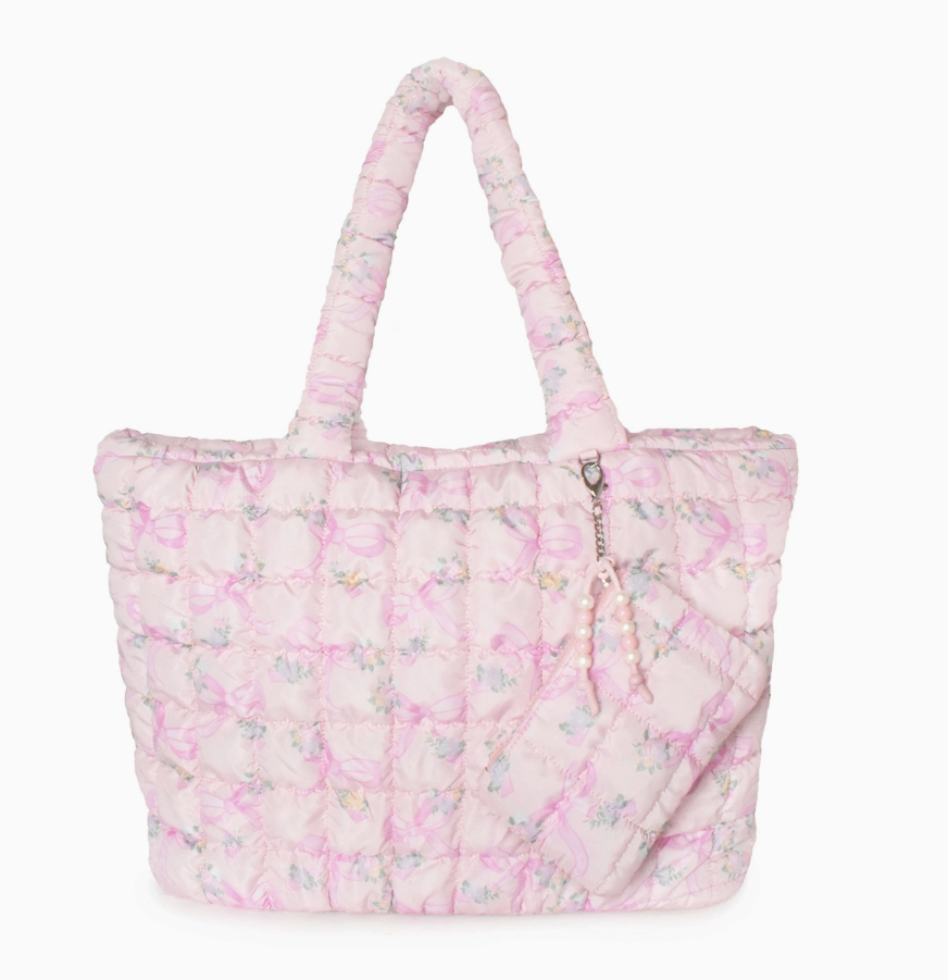 Pink quilted tote bag with floral pattern on a white background