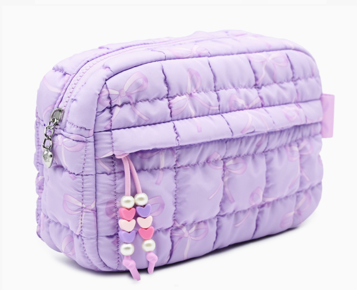 Purple quilted bag with decorative elements on a white background