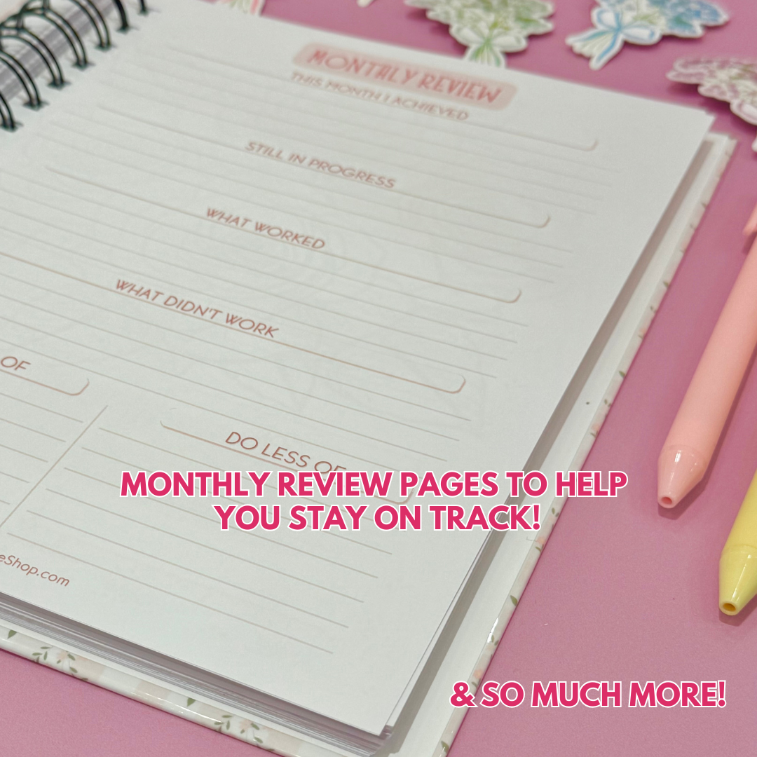 Daily Planner surrounded by stationery items on a pink background