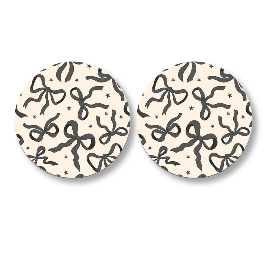 set of car coasters with black bow pattern design