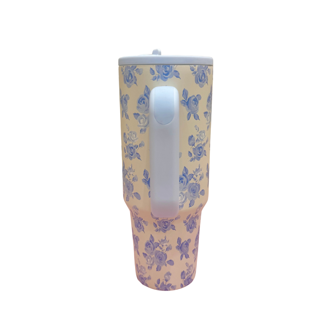 Tumbler with blue floral pattern on a white background