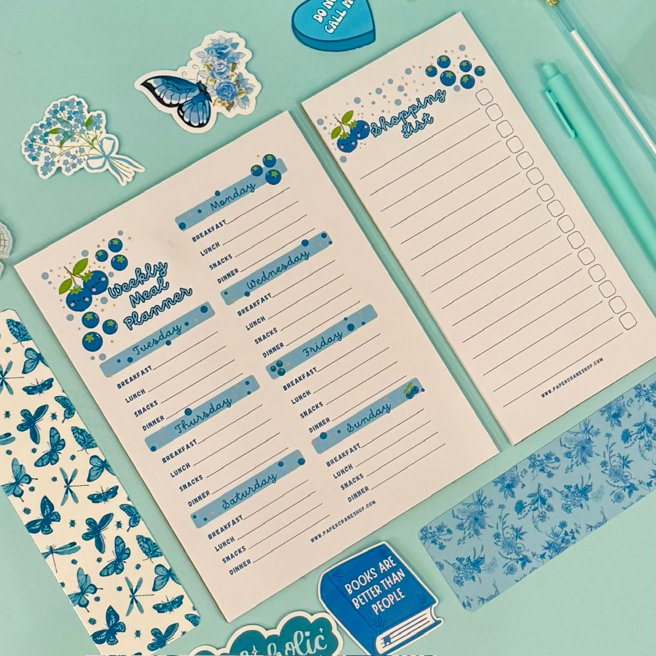 Weekly meal planner and to-do list on a teal background with decorative elements.