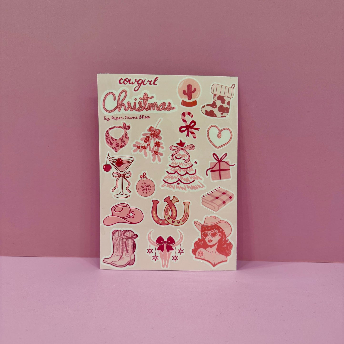 Notebook with pink illustrations and 'Cowgirl Christmas' text on a pink background