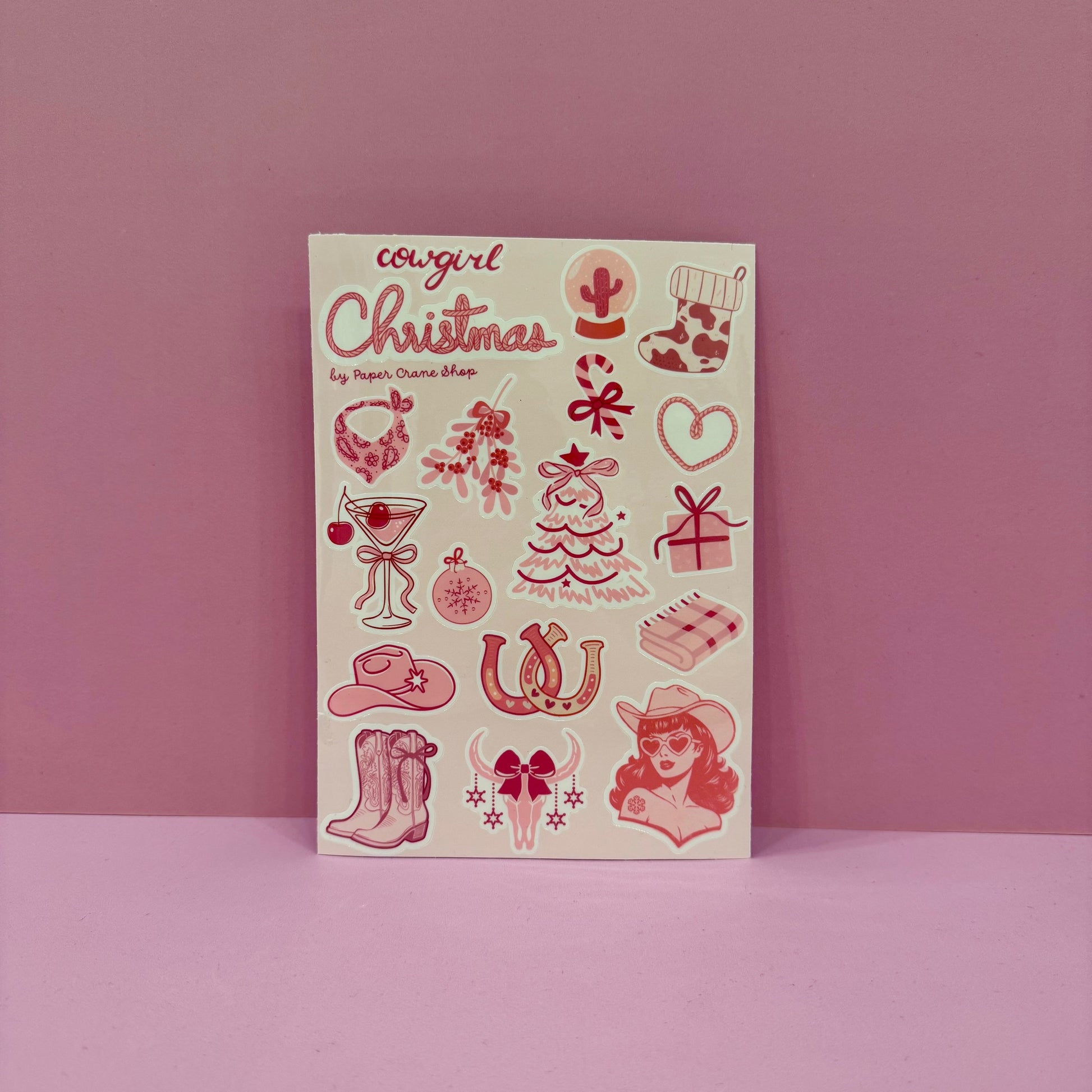 Notebook with pink illustrations and 'Cowgirl Christmas' text on a pink background