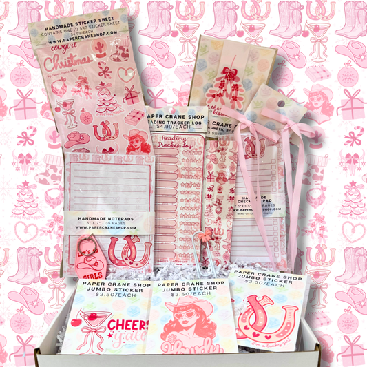 Collection of stationery items including stickers and notepads on a pink patterned background.