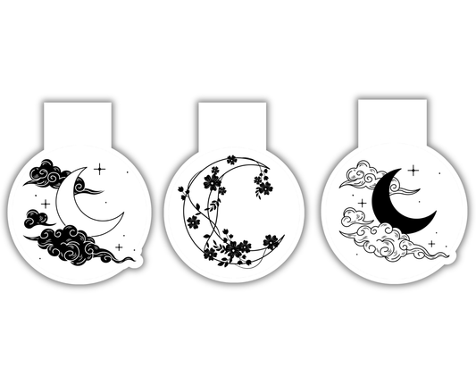 Three magnetic bookmarks with crescent moon and floral designs on a white background