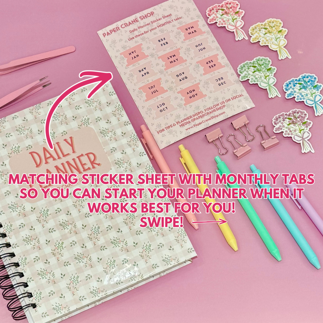 Daily Planner surrounded by stationery items on a pink background