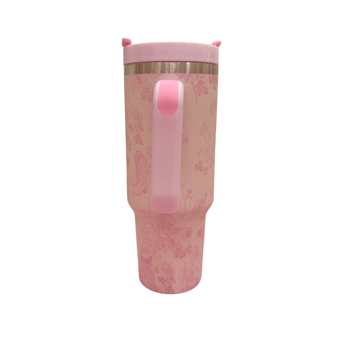 Pink tumbler with floral pattern on a white background