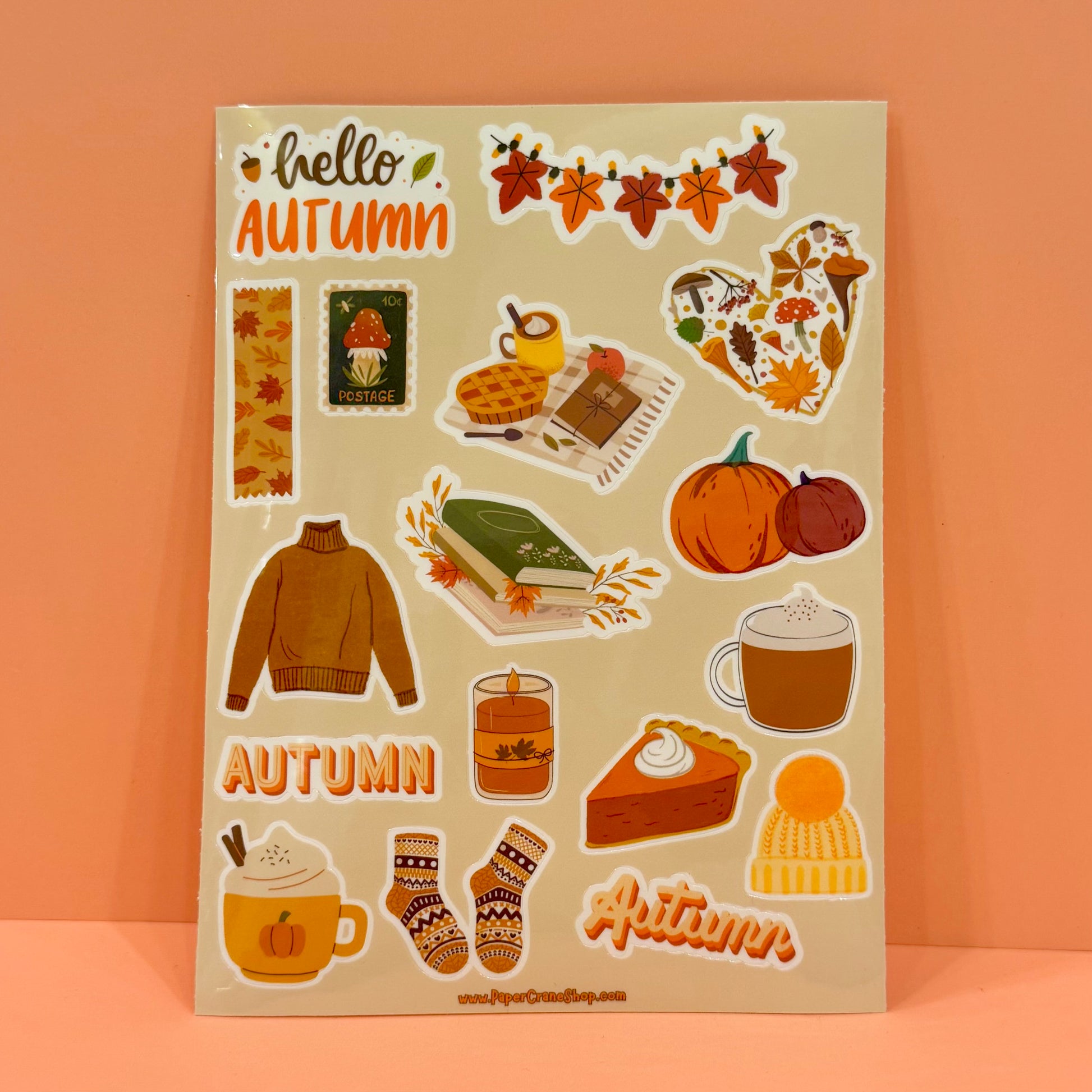Sheet of autumn-themed stickers with pumpkins, leaves, and other fall elements on a beige background.