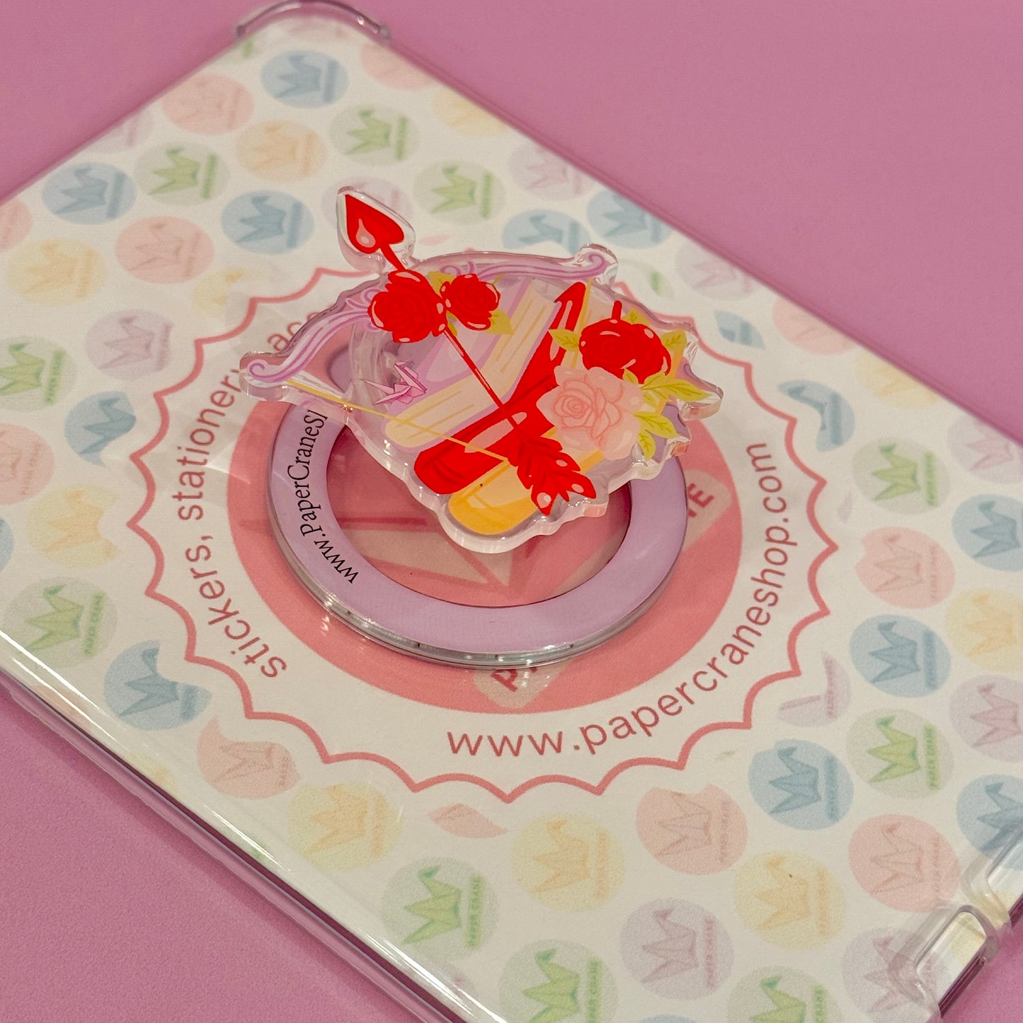 Decorative magsafe phone holder with a colorful design with books, roses and bow and arrow