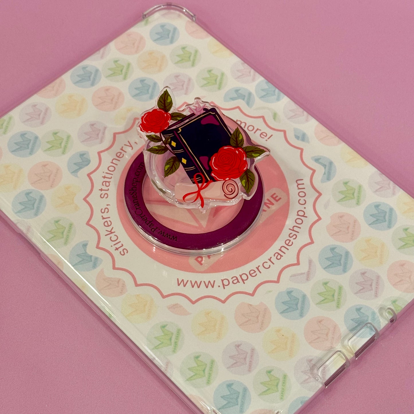 Phone ring holder with floral design on a stationery item packaging