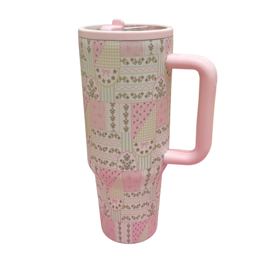 Pink travel mug with patterned design on a white background