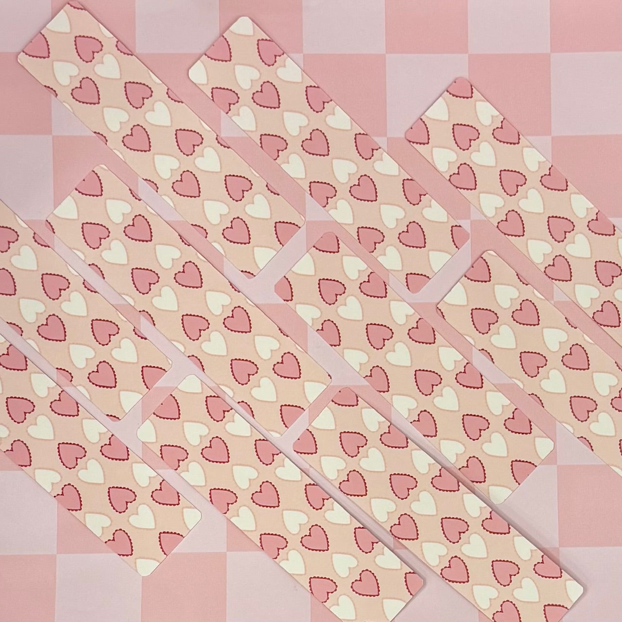 heart-patterned bookmarks on a grid background