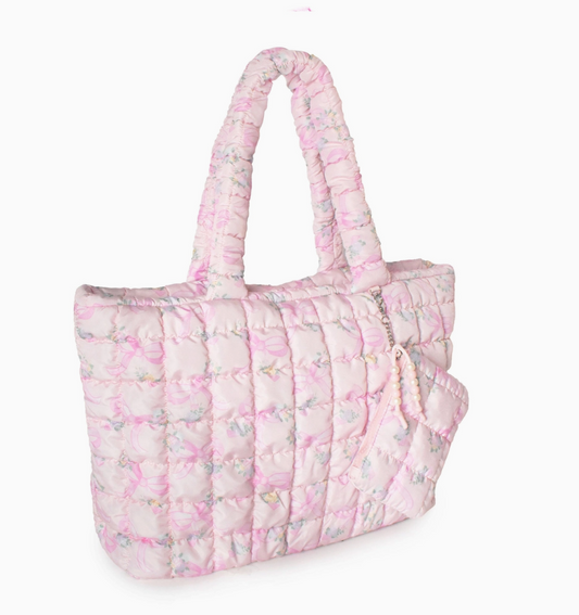 Pink quilted tote bag with floral pattern on a white background