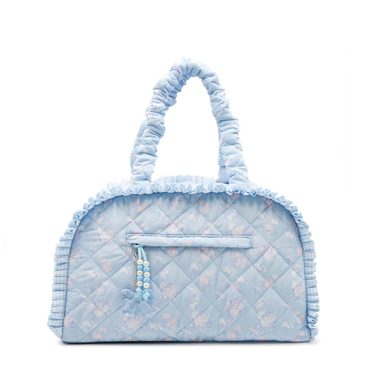 Medium quilted duffle bag lined with ruffles with a blue floral pattern