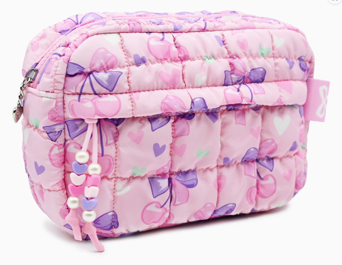 Pink quilted cosmetic bag with bow pattern on a white background