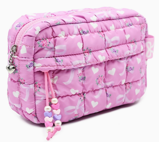 Pink quilted bag with heart pattern and decorative string on a white background