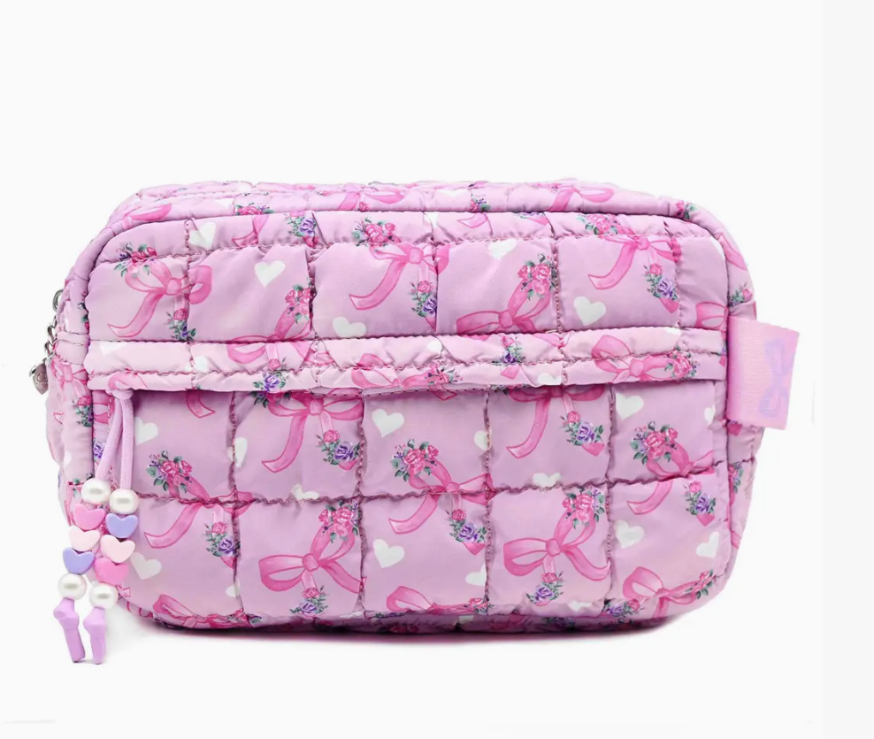 Pink quilted bag with bow pattern on a white background