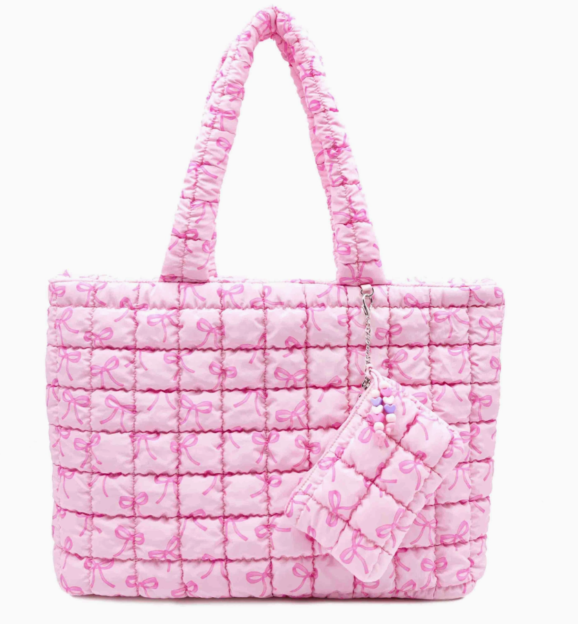 Pink quilted tote bag with bow pattern on a white background