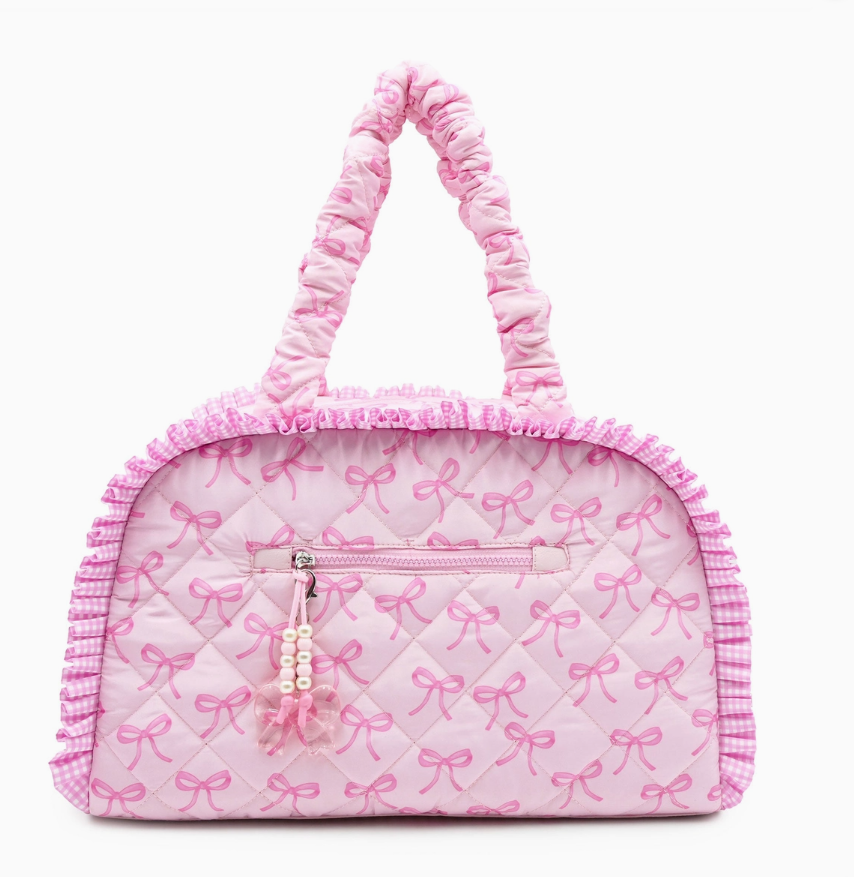 Pink  duffle bag with bow pattern on a white background