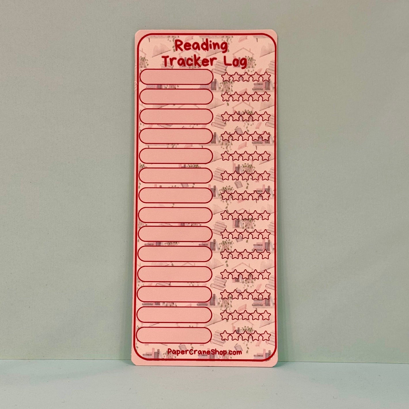 Pink reading tracker log on a gray background
