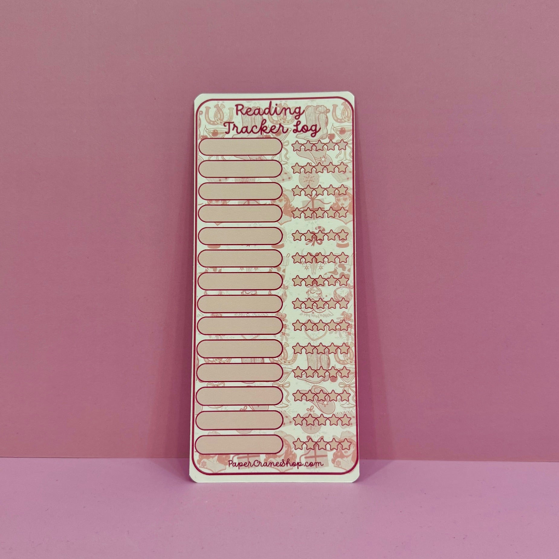 Reading tracker sheet on a pink background