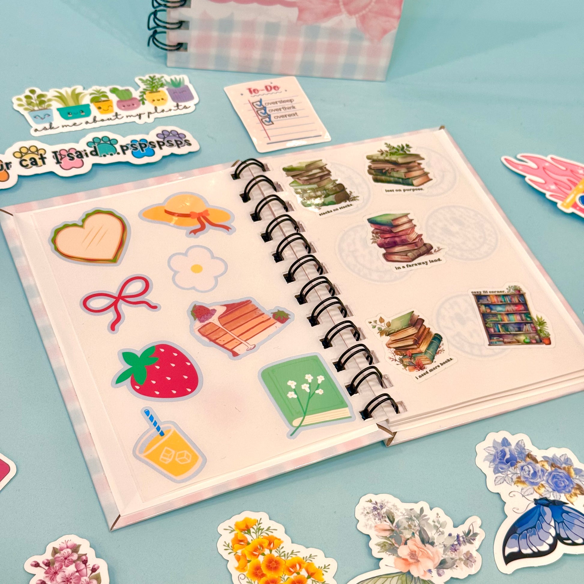 Open notebook with stickers on a light blue background