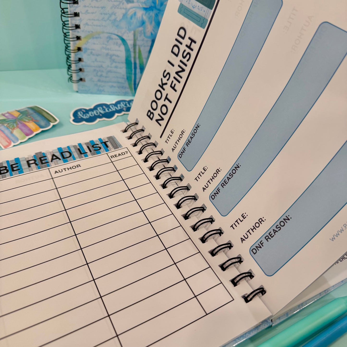 Notebook with reading logs and bookmarks on a colorful background