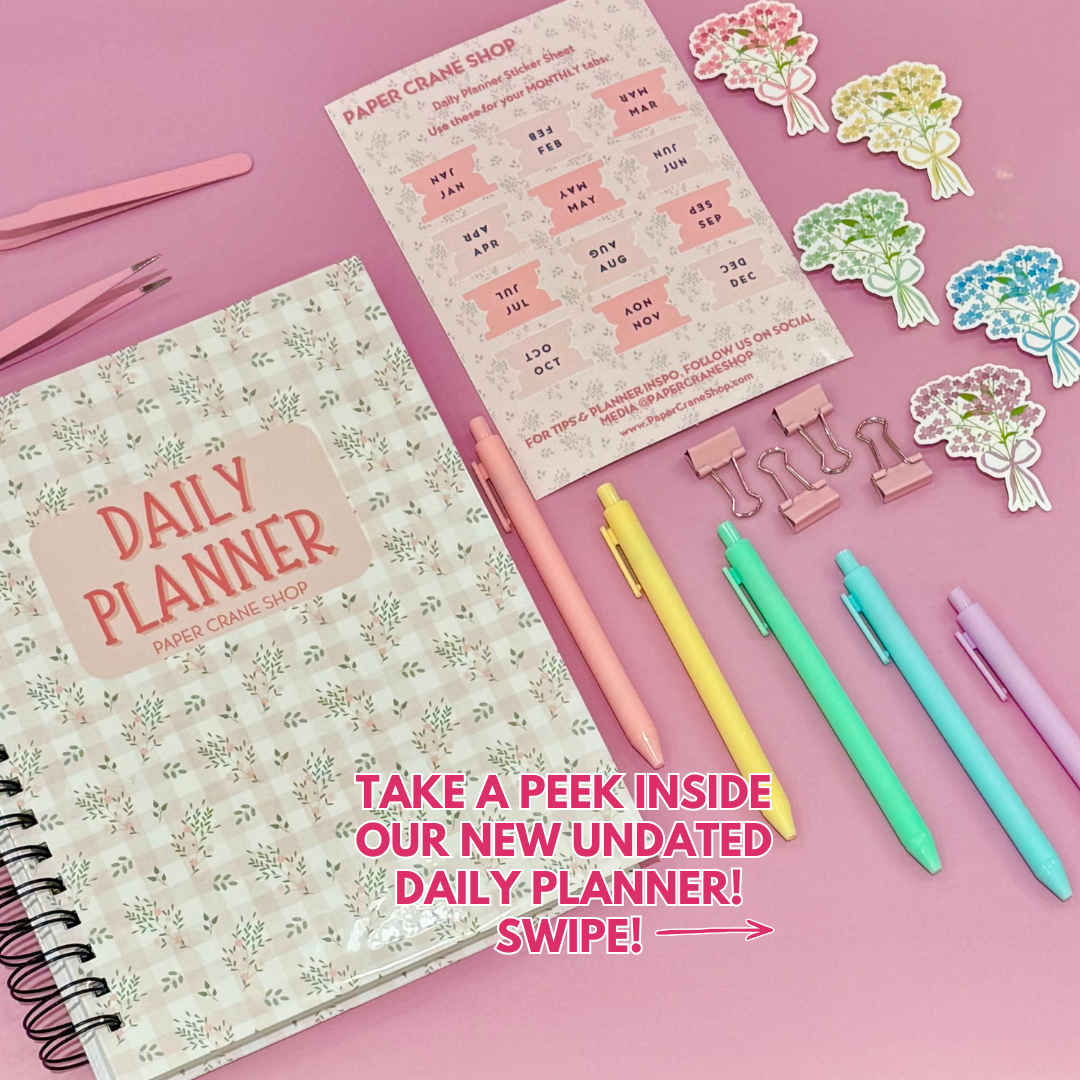 Daily Planner surrounded by stationery items on a pink background
