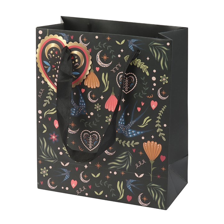 Decorative gift bag with colorful heart and floral pattern on a black background