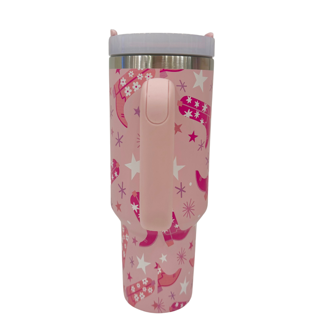 Pink tumbler with boots and star pattern on a white background