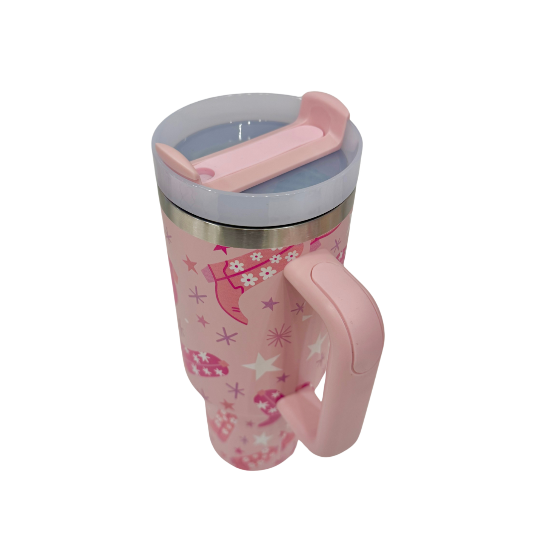 Pink tumbler with handle and lid on a white background