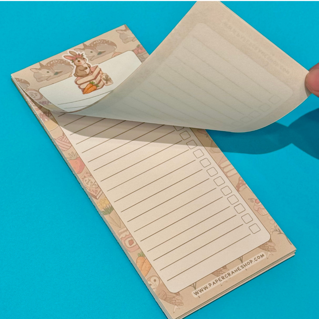 Notebook with lined pages and decorative border on a blue background