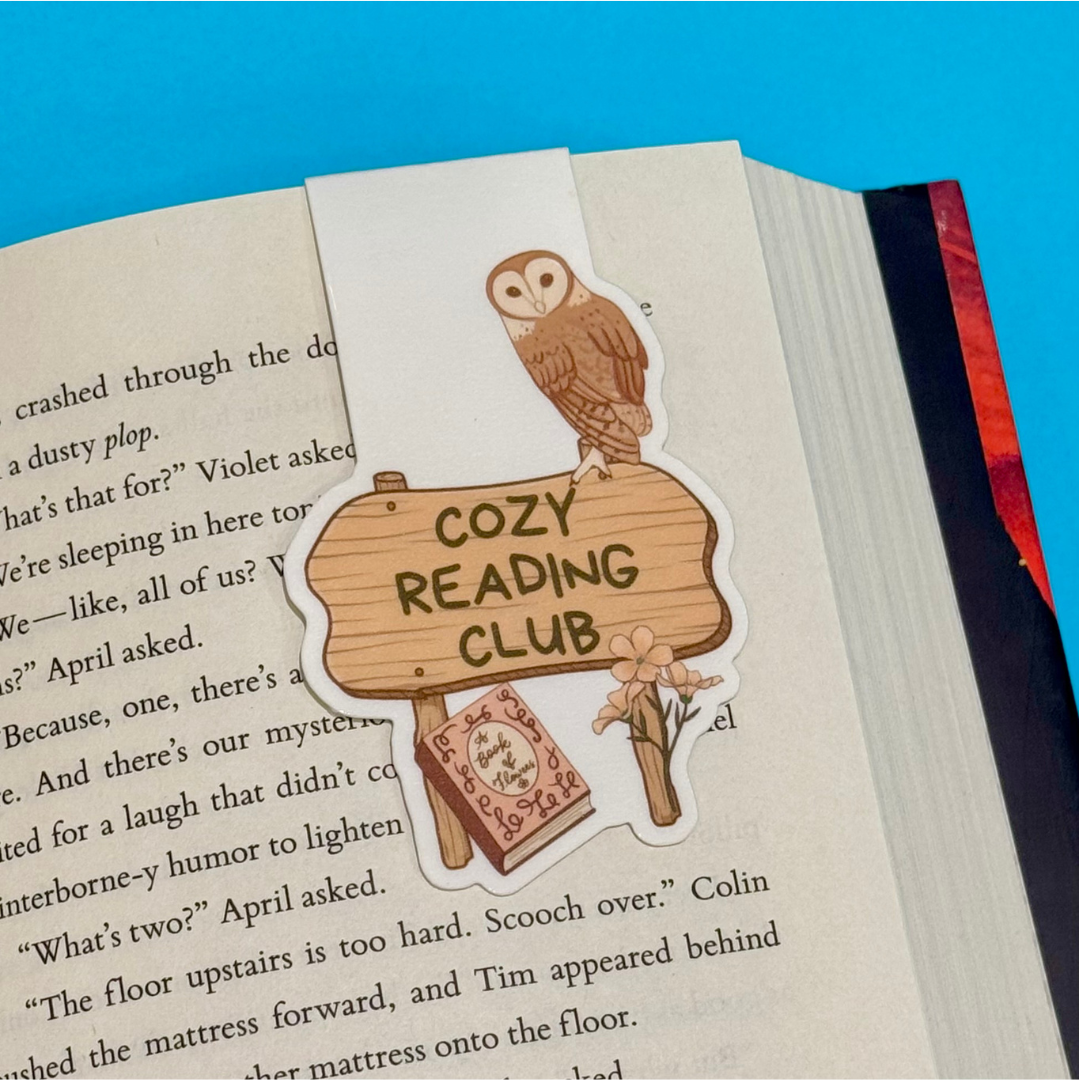 Owl magnetic bookmark on a book with 'Cozy Reading Club' text against a blue background