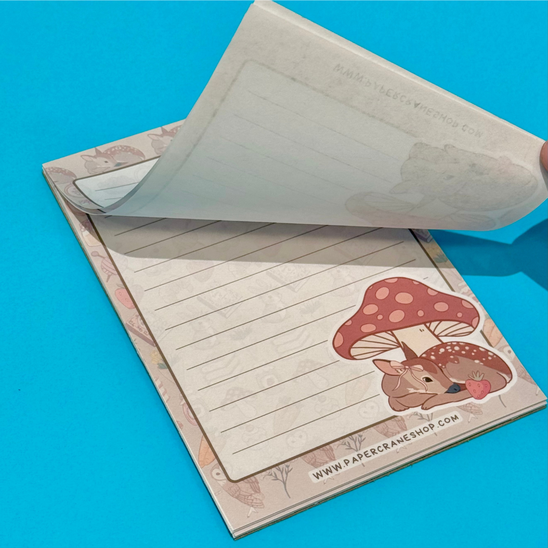 Notebook with a cute illustration of a deer and mushroom on a blue background