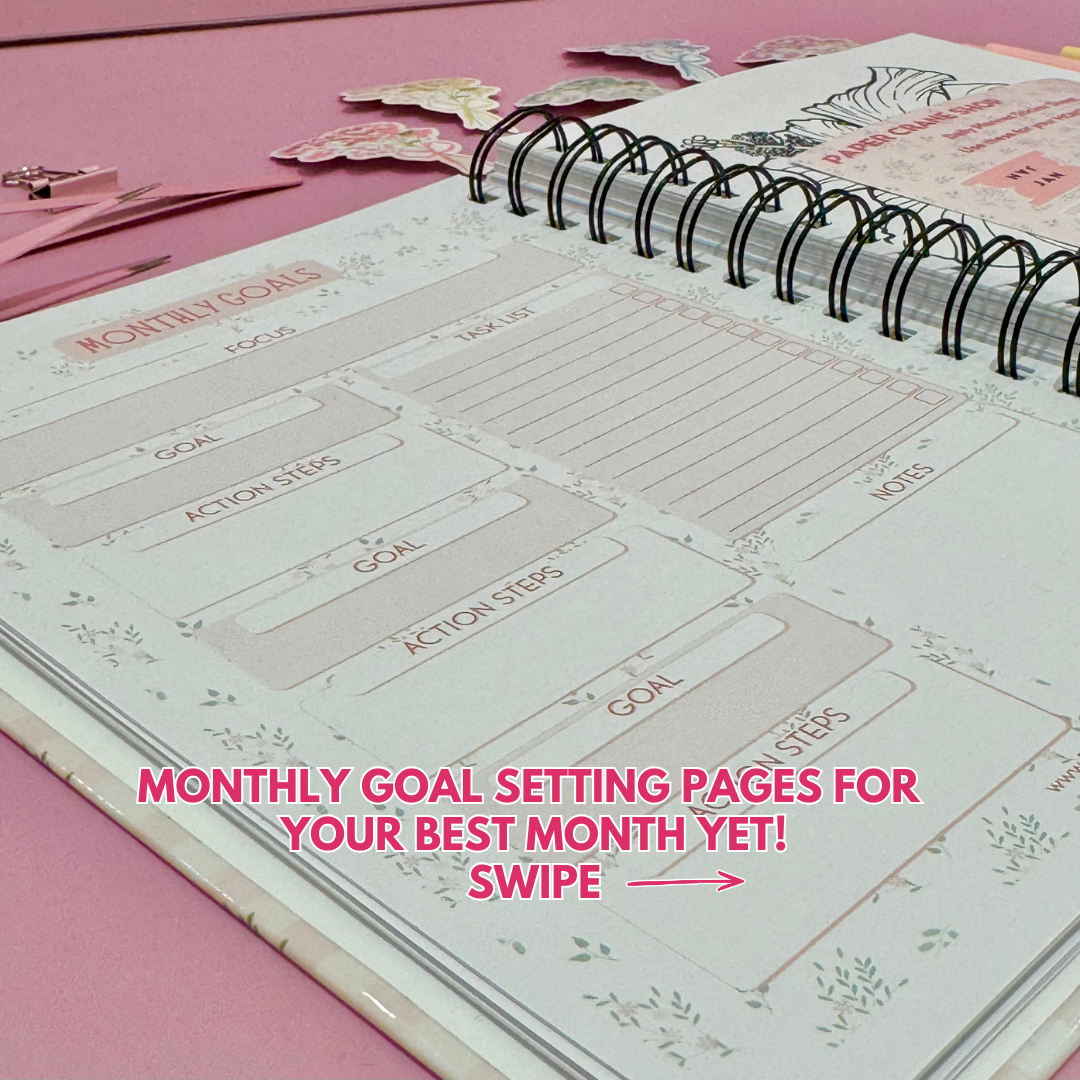 Daily Planner surrounded by stationery items on a pink background
