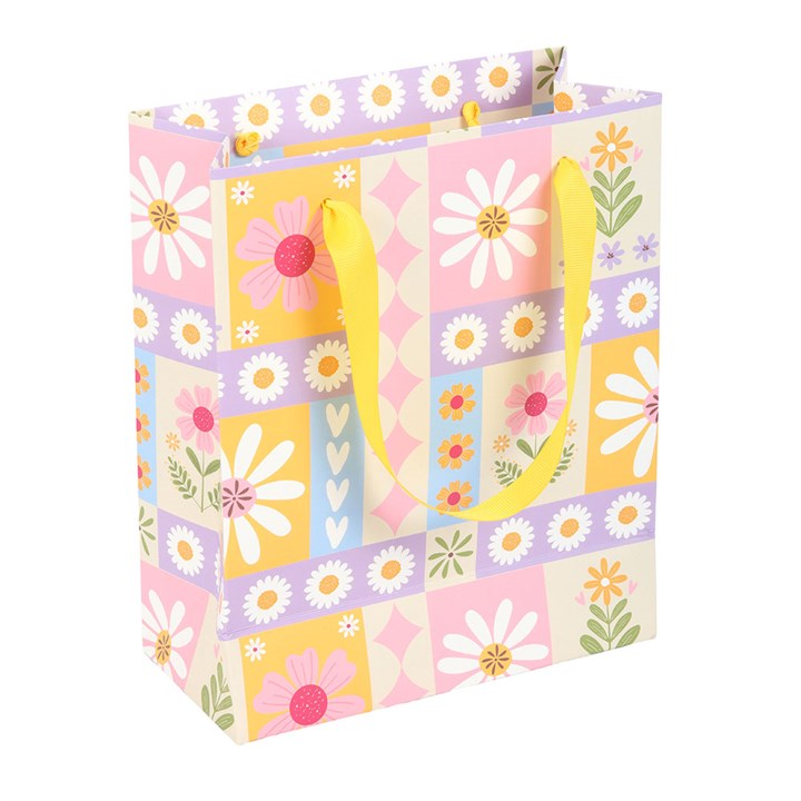 Colorful floral-patterned gift bag with a yellow handle on a white background