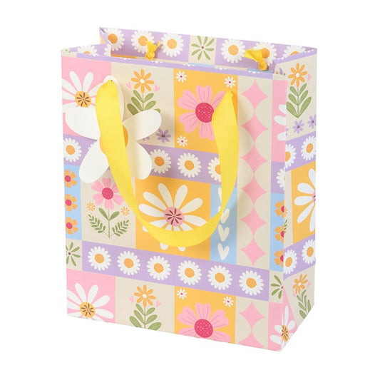 Gift bag with floral pattern and yellow handle on a white background