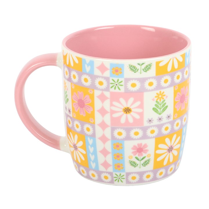 Colorful floral-patterned mug with a pink interior on a white background