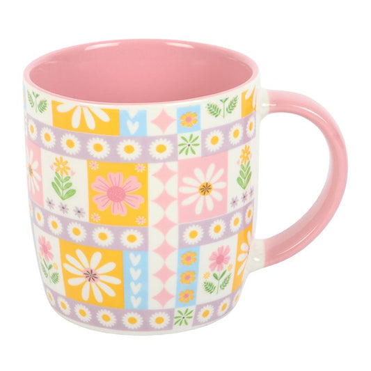 Mug with floral pattern and pink handle on a white background