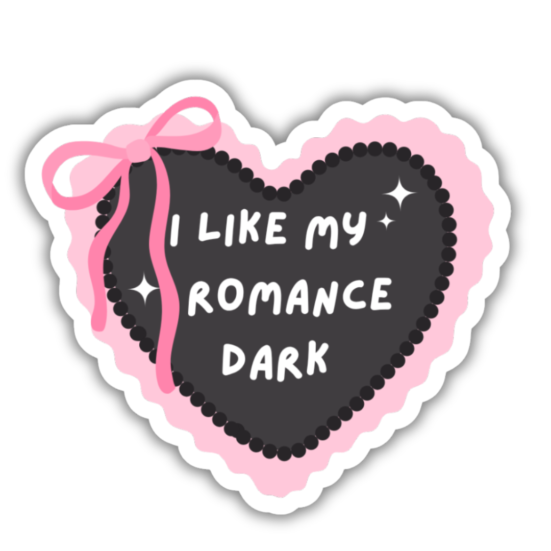 Heart-shaped sticker with pink ribbon and text 'I LIKE MY ROMANCE DARK' on a white background