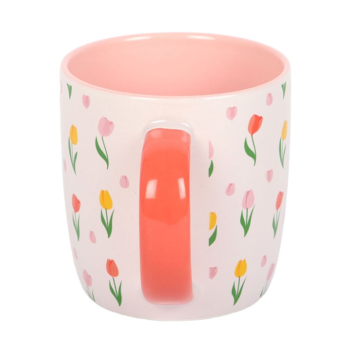 Mug with floral pattern and pink interior on a white background
